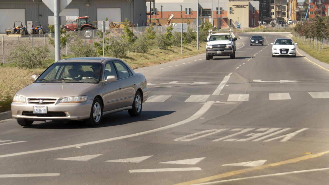 Cars drive on campus.
