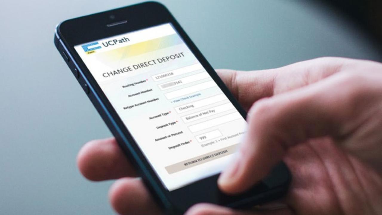 UCPath "Change Direct Deposit" page shows on phone screen.