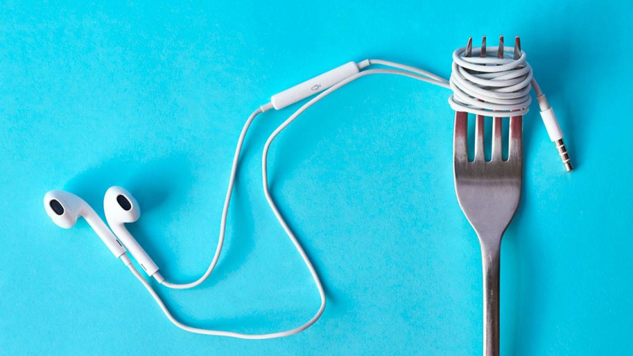 "Unfold" logo, cropped, showing earphones wrapped around a fork.