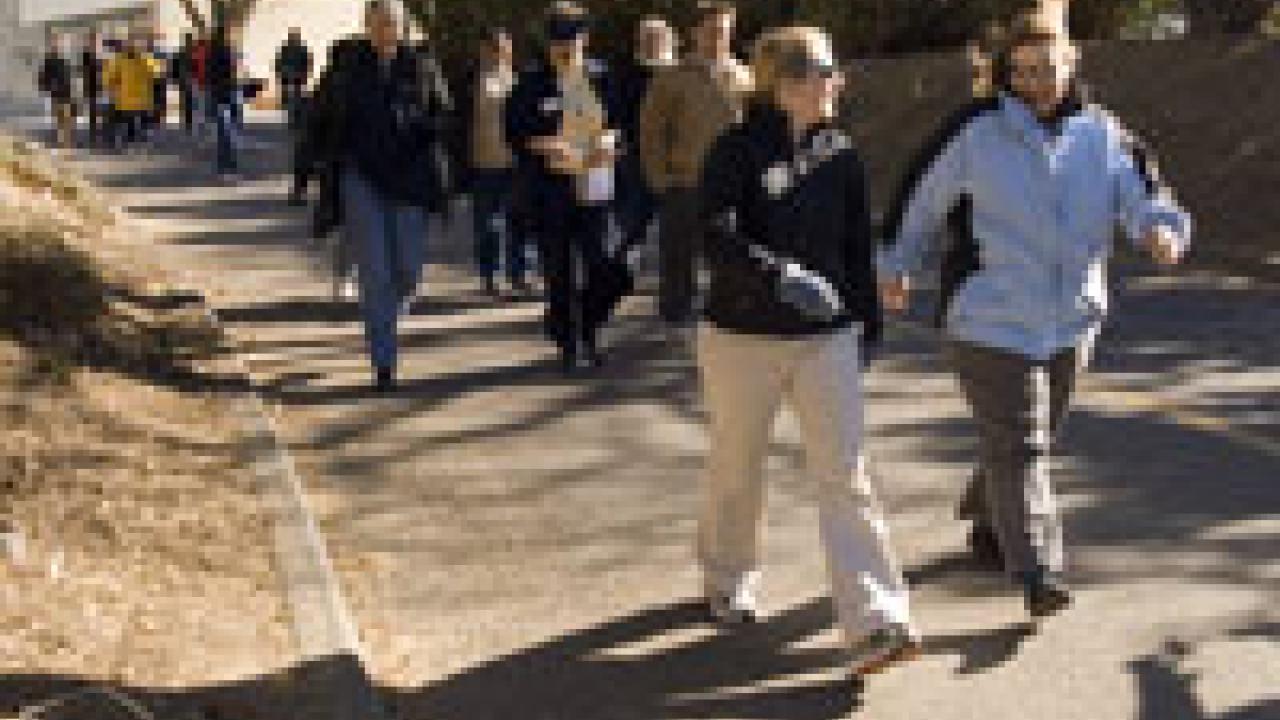 Nearly two dozen people set out on a group walk with Provost Virginia
Hingham, center in the second row, as part of the Winter Walkabout sponsored by Aggie On the Move on Jan. 17. The walk began in the ARC, where the provost gave a short pep ta