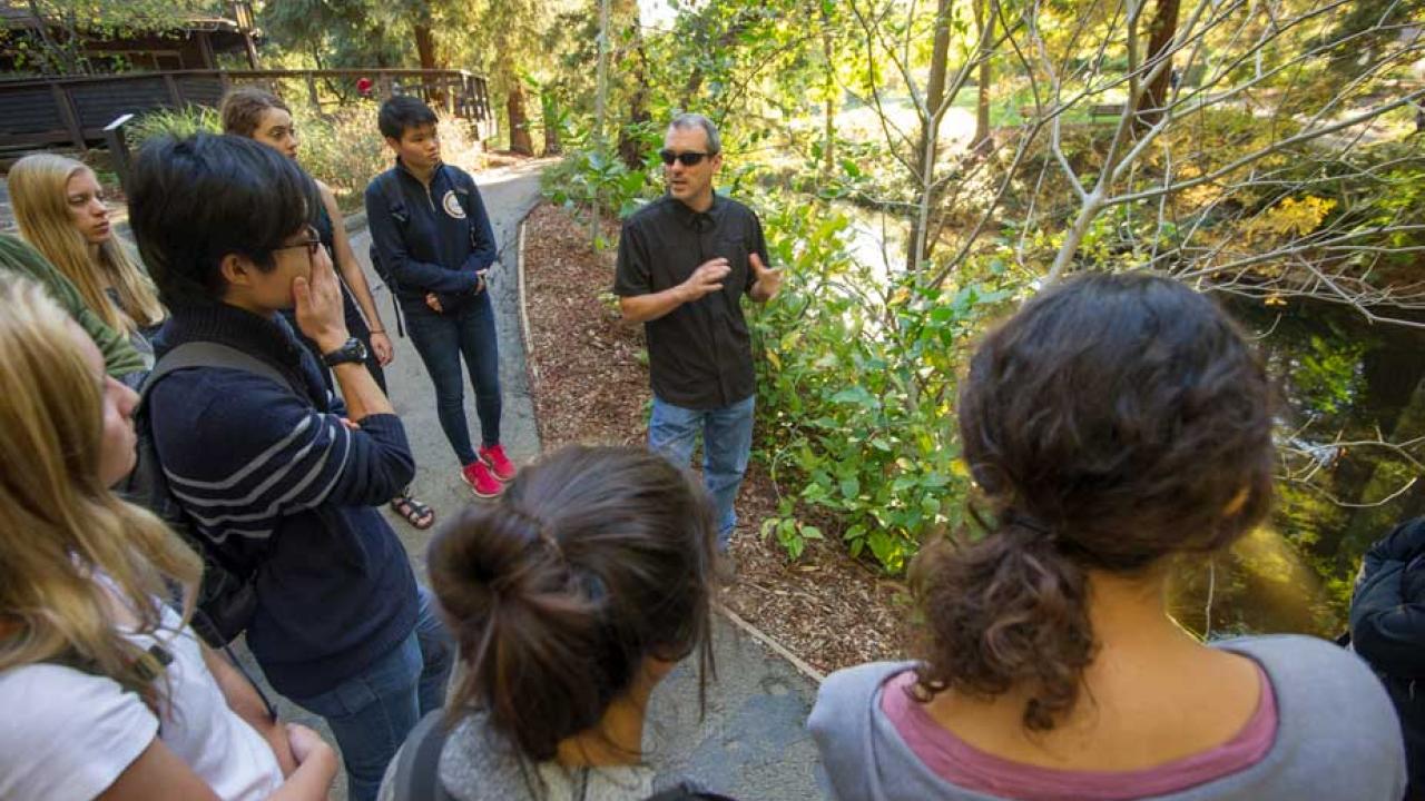 Andrew Fulks speaks to class along the Arboretum Waterway.