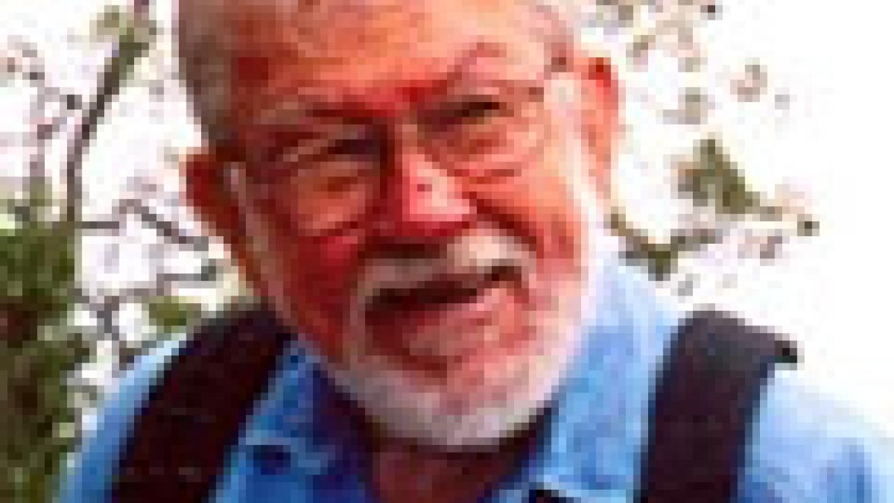 photo: man's face and upper torso with tree in background