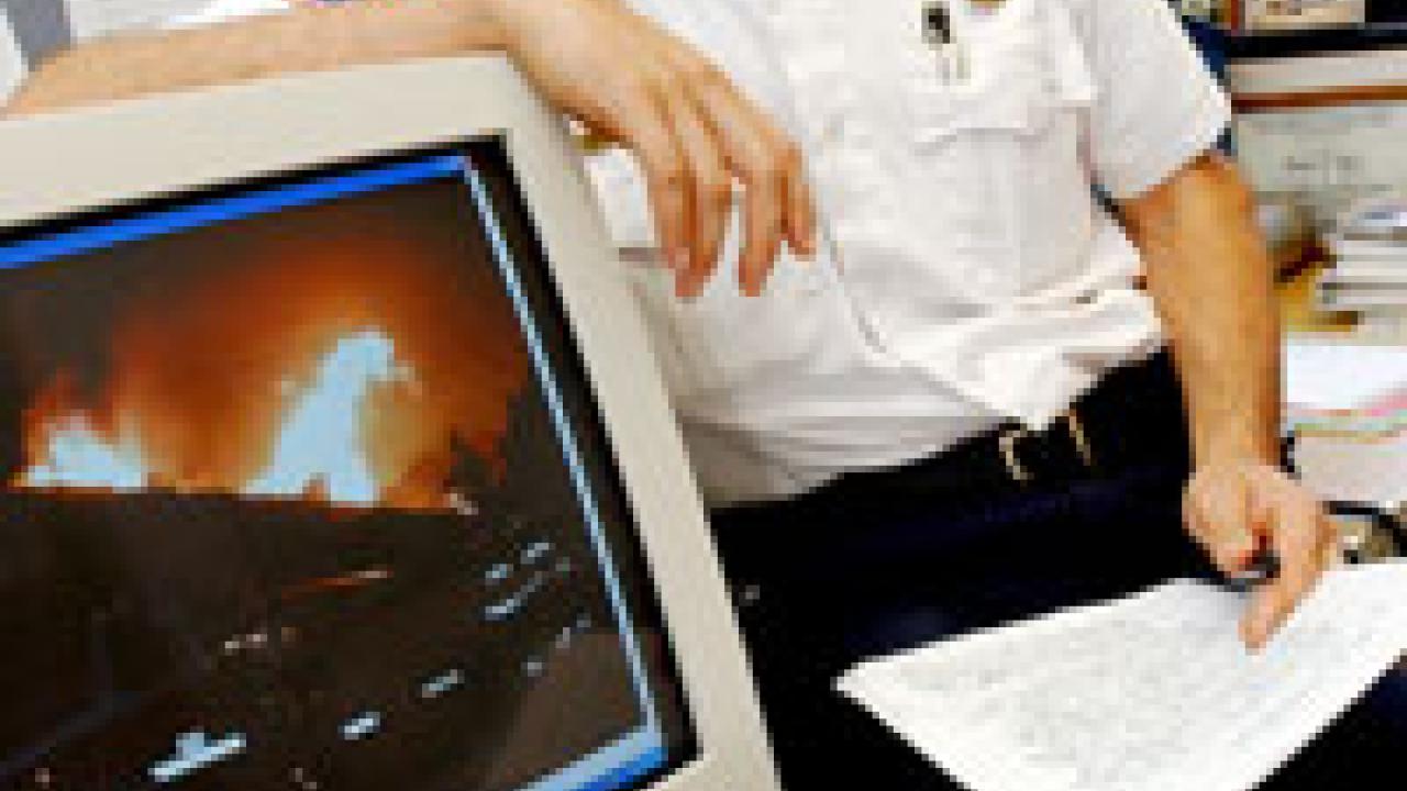 Wes Arvin pulls an image taken at the &ldquo;Old Fire,&rdquo; the name given to the recent San Bernardino Hills blaze, onto his computer. Arvin&rsquo;s team saved about 13 houses and, &ldquo;most importantly,&rdquo; he says, &ldquo;all returned home safely.&rdquo;