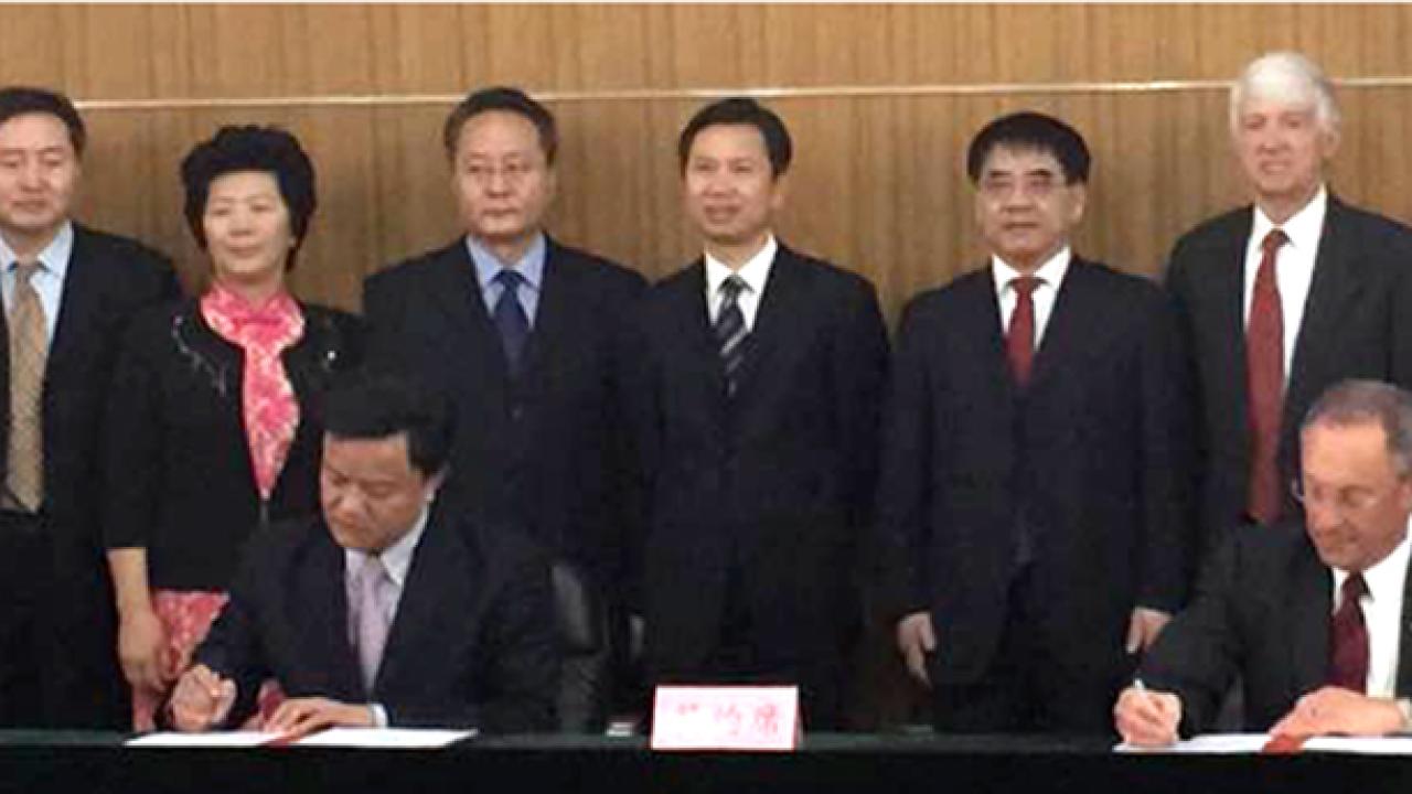 Photo: Ralph J. Hexter signs memorandum of understanding.