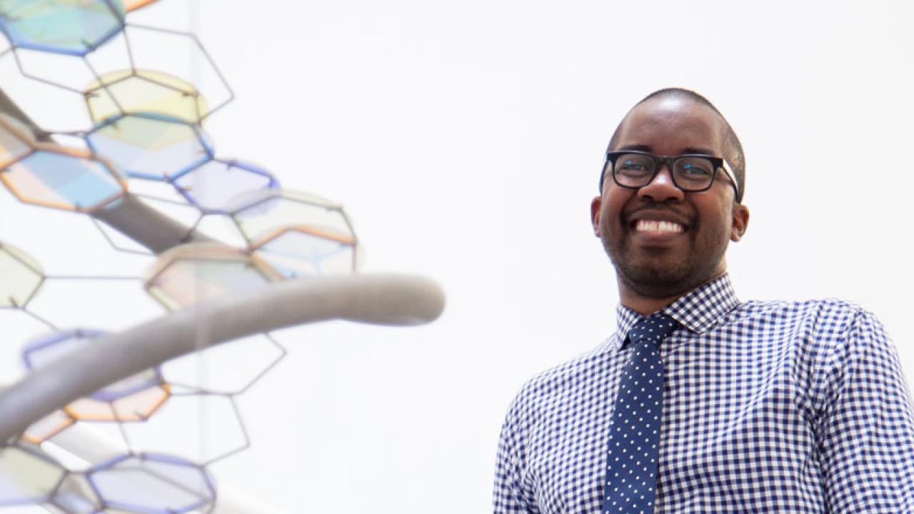 Wilsaan Joiner poses next to DNA sculpture.