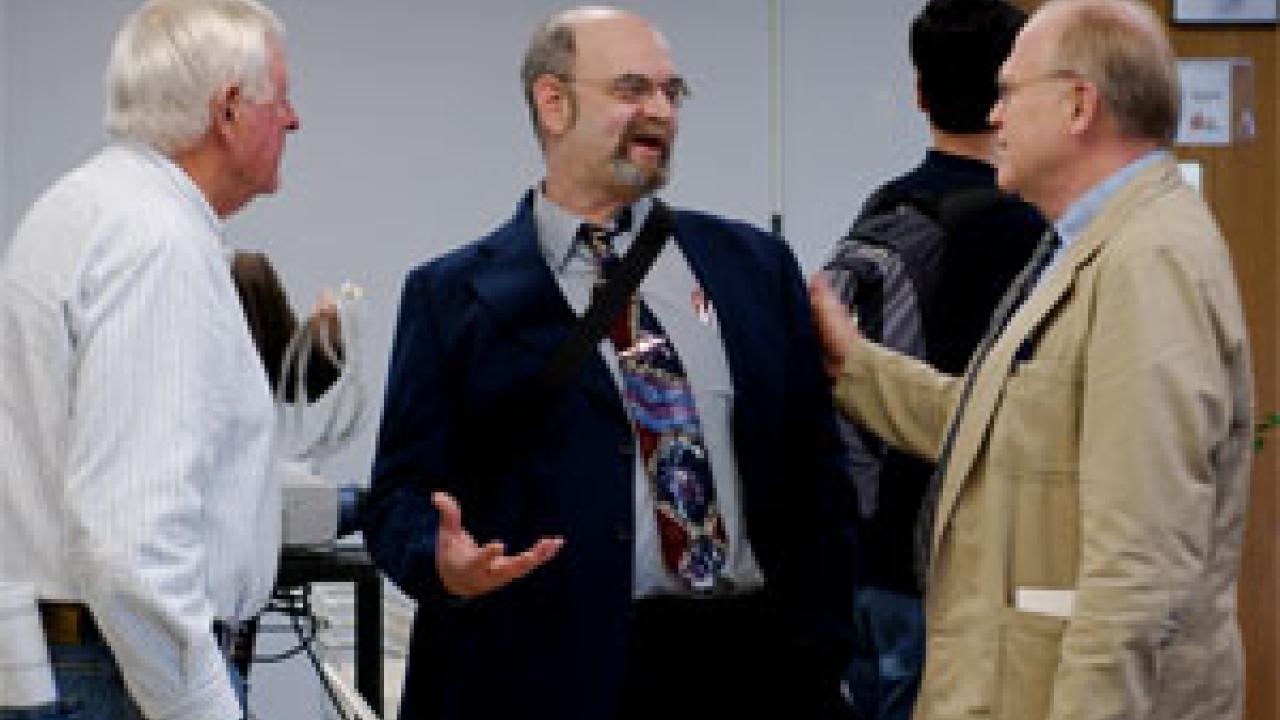 Emeritus professor Murray Gardner, left, grad student hopeful Howard Zochlinski, center, and Professor Peter Rodman talk after the academic senate vote to reinstate Zochlinski, a former doctoral genetics student, to graduate student status. Zoch