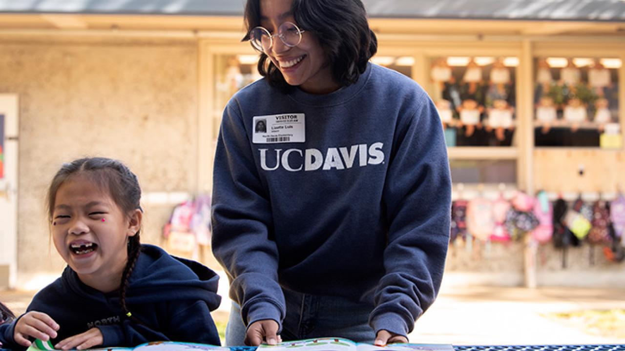 Lizette Luis works with kids at North Davis Elementary School