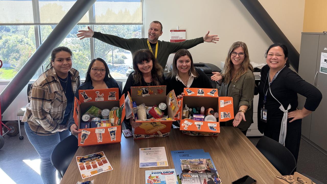 a group of people with boxes of back to school supplies