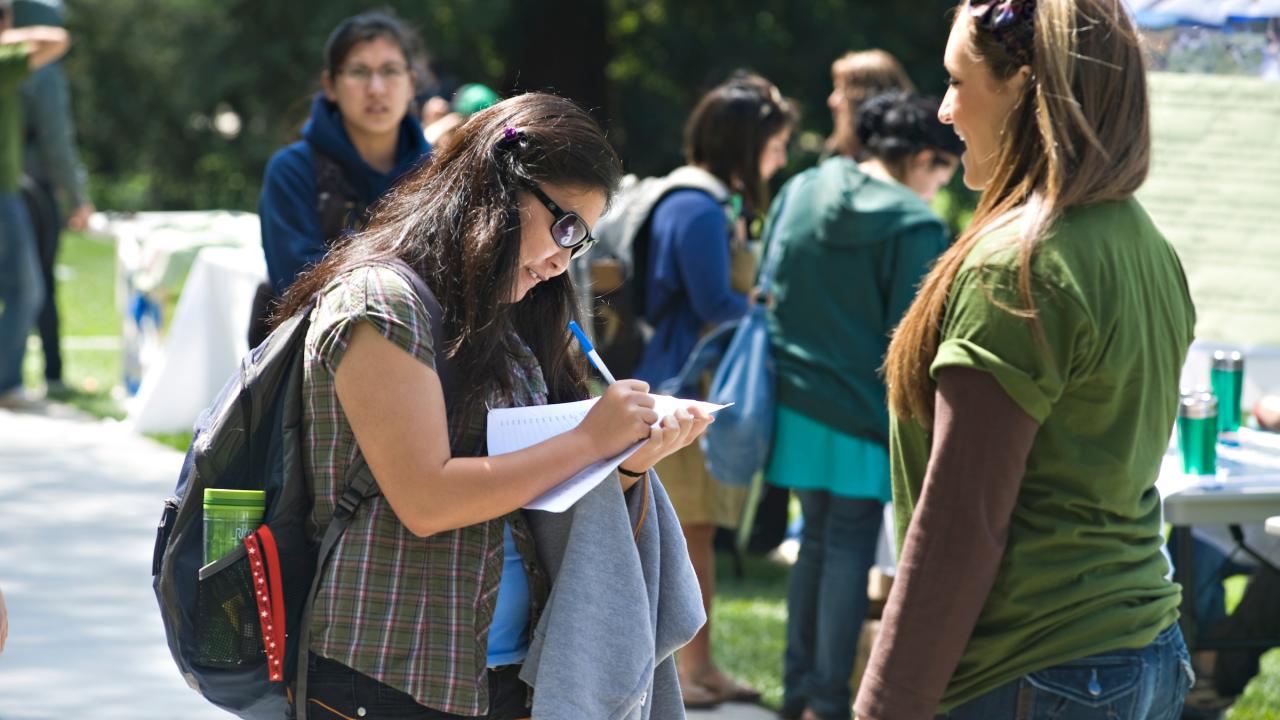 Woman signs petition at Earth Day festival