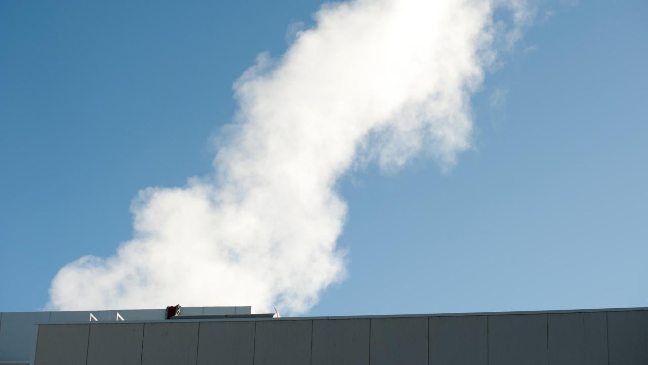 Water vapor as fluffy white plume, coming from the steam plant
