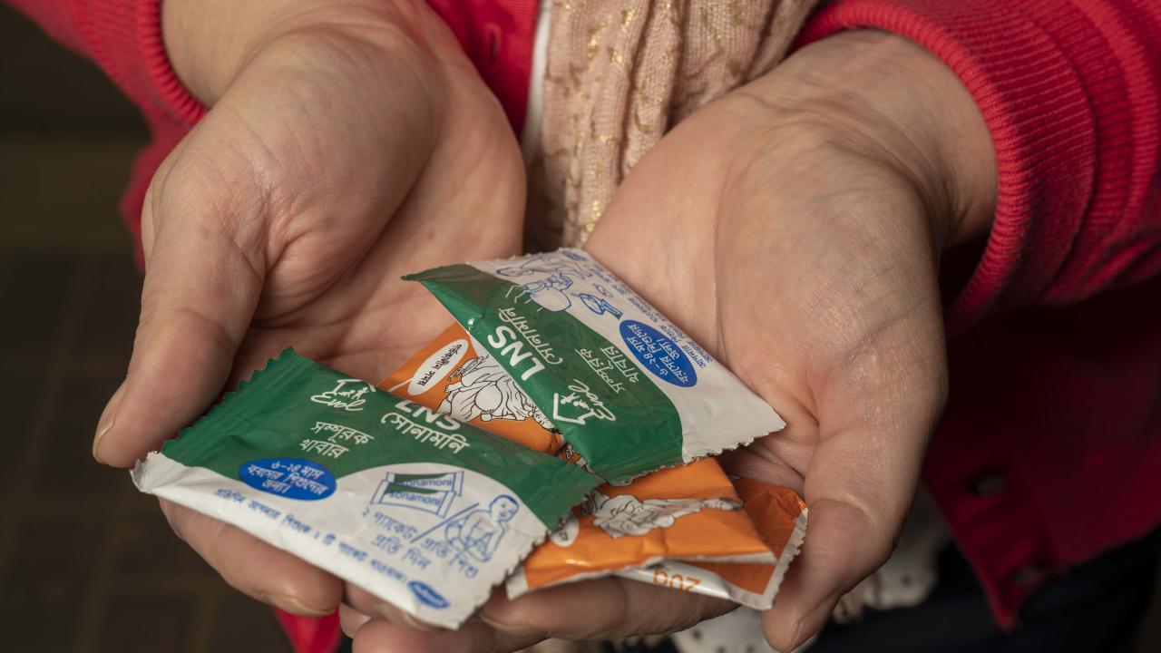 Researcher holding nutritional supplements