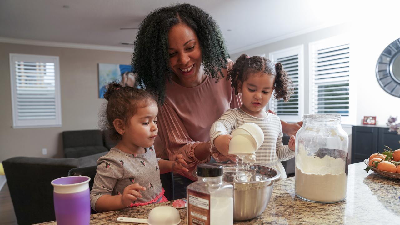 a mother and 2 daughters in the kitchen