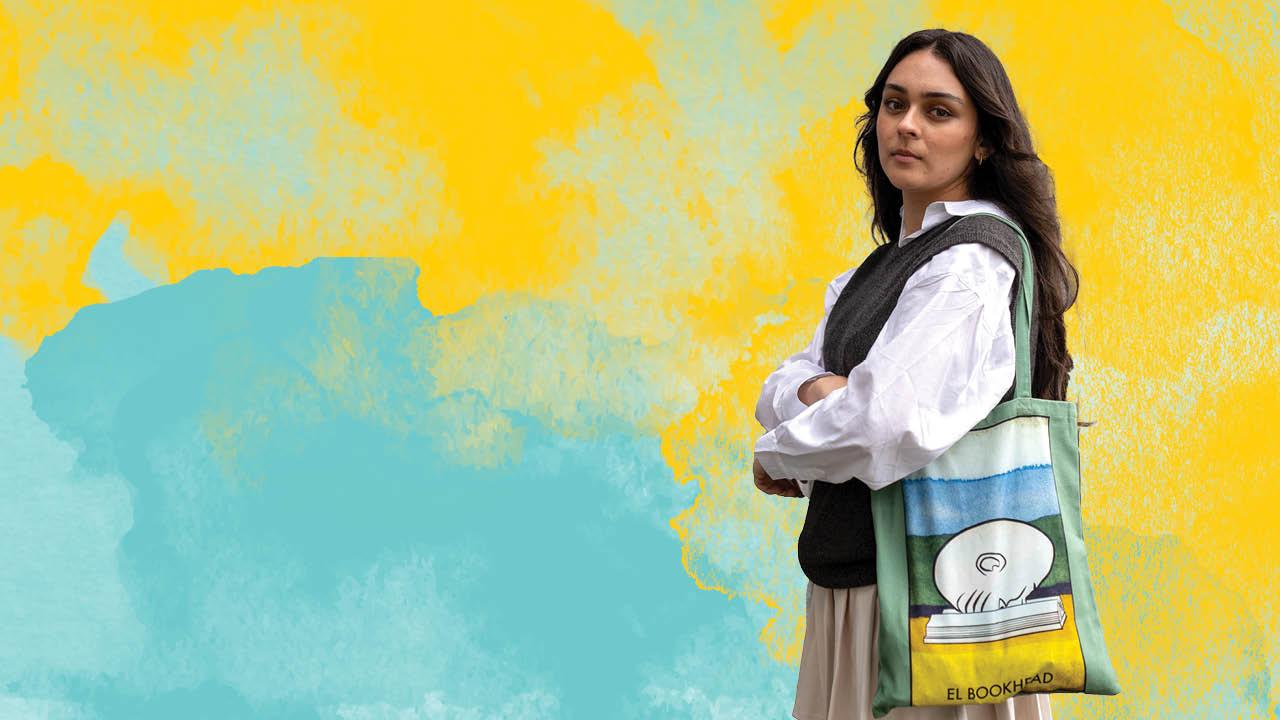 A UC Davis student modeling an egghead themed tote bag