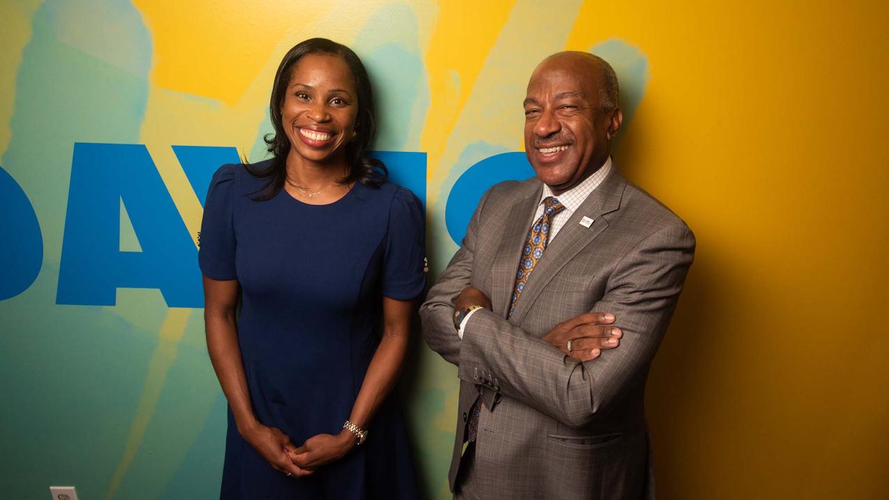 Marcia Faustin standing next to Chancellor Gary S. May