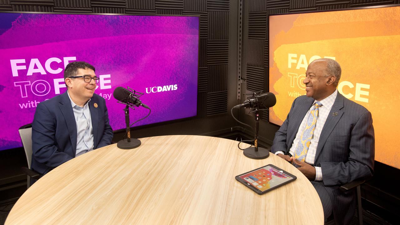 Luis Carvajal-Carmona sitting next to Chancellor May