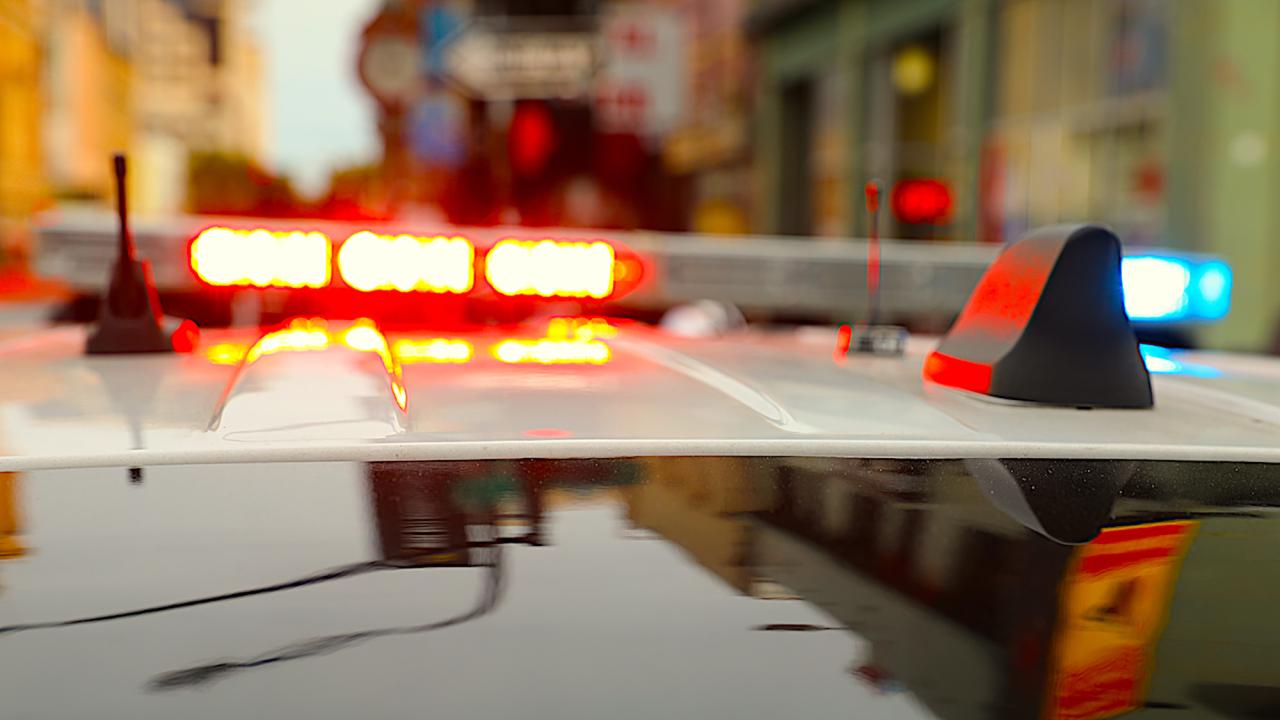 Roof of a police cruiser with red lights on lightbar