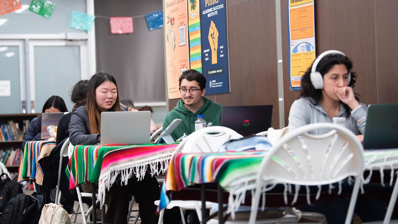 Three Students study at tables in the Center for Chicanx and Latinx Academic Student Success