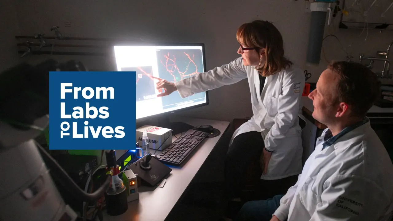 Photo of two scientists looking at a screen with logo superimposed: From Labs to Lives