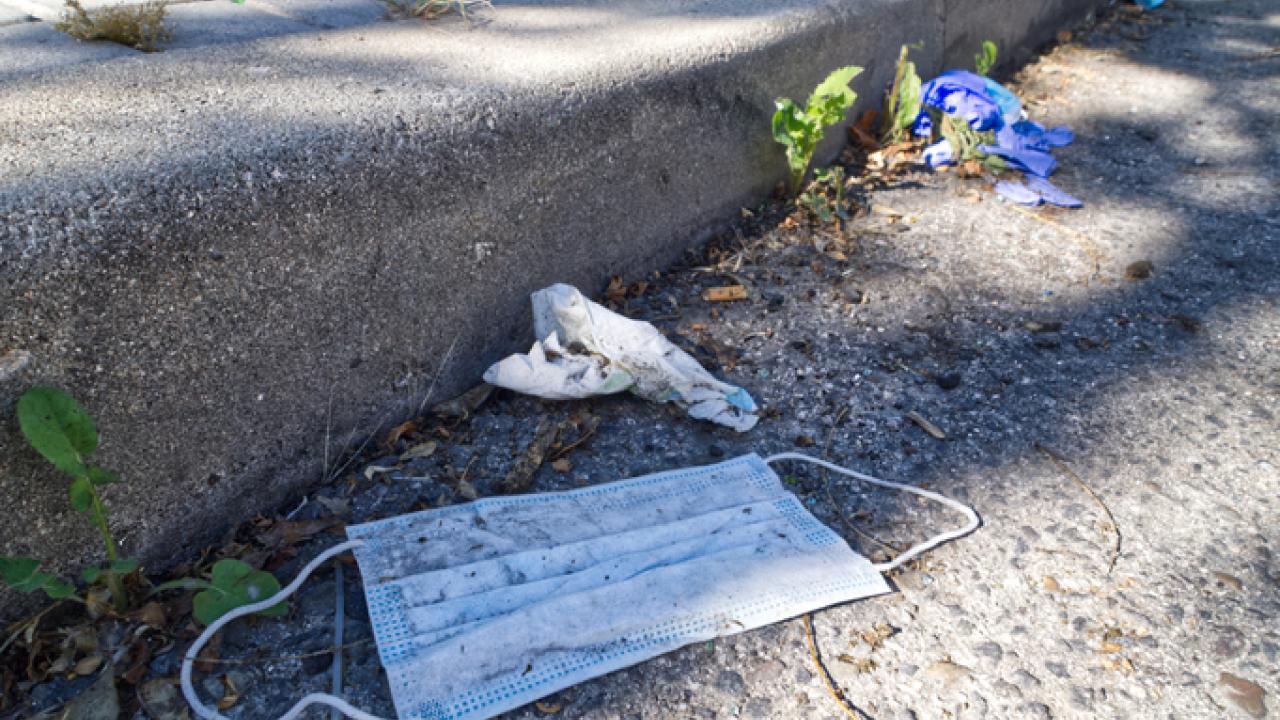 Discarded face mask in gutter