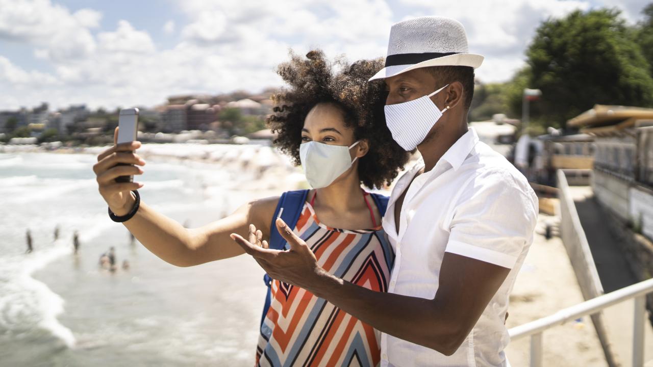 Couple taking selfie on beach sidewalk