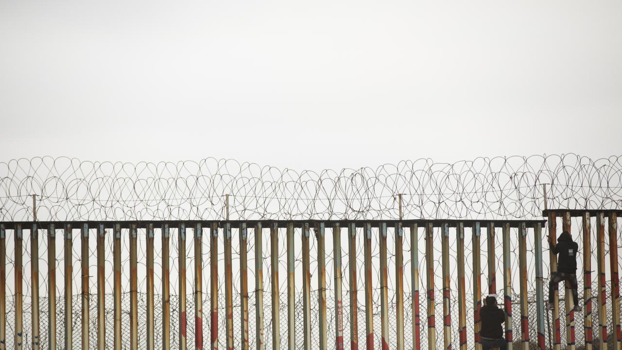 A grayish scene of a border fence