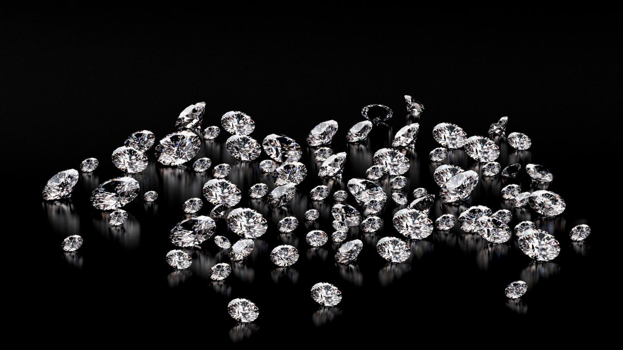 A scattering of bright clear crystals against a black background.
