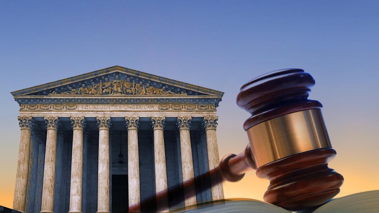 Supreme Court building with gavel in foreground.