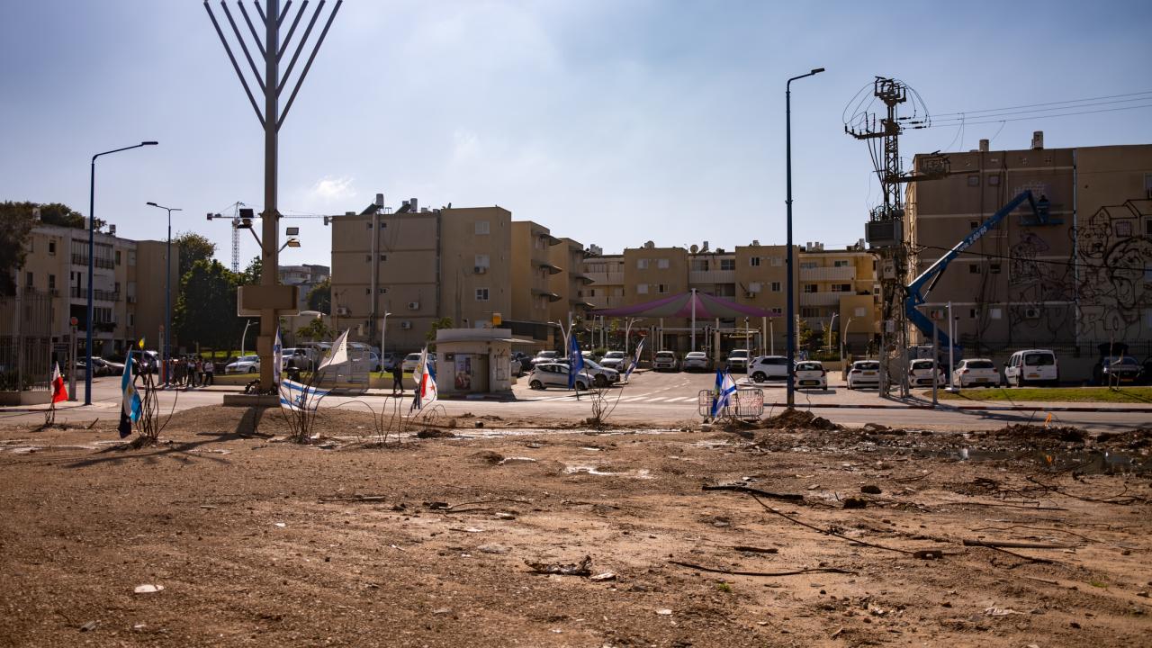 empty field with partial city behind it in Israel.