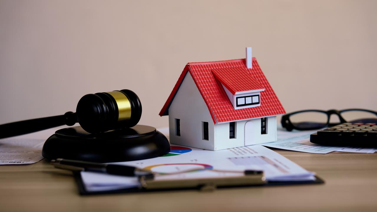 composite photo of gavel and house model