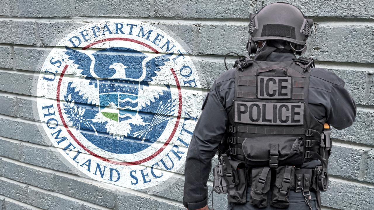 Photo of ICE agent in front of gray wall that says Department of Homeland Security via a logo