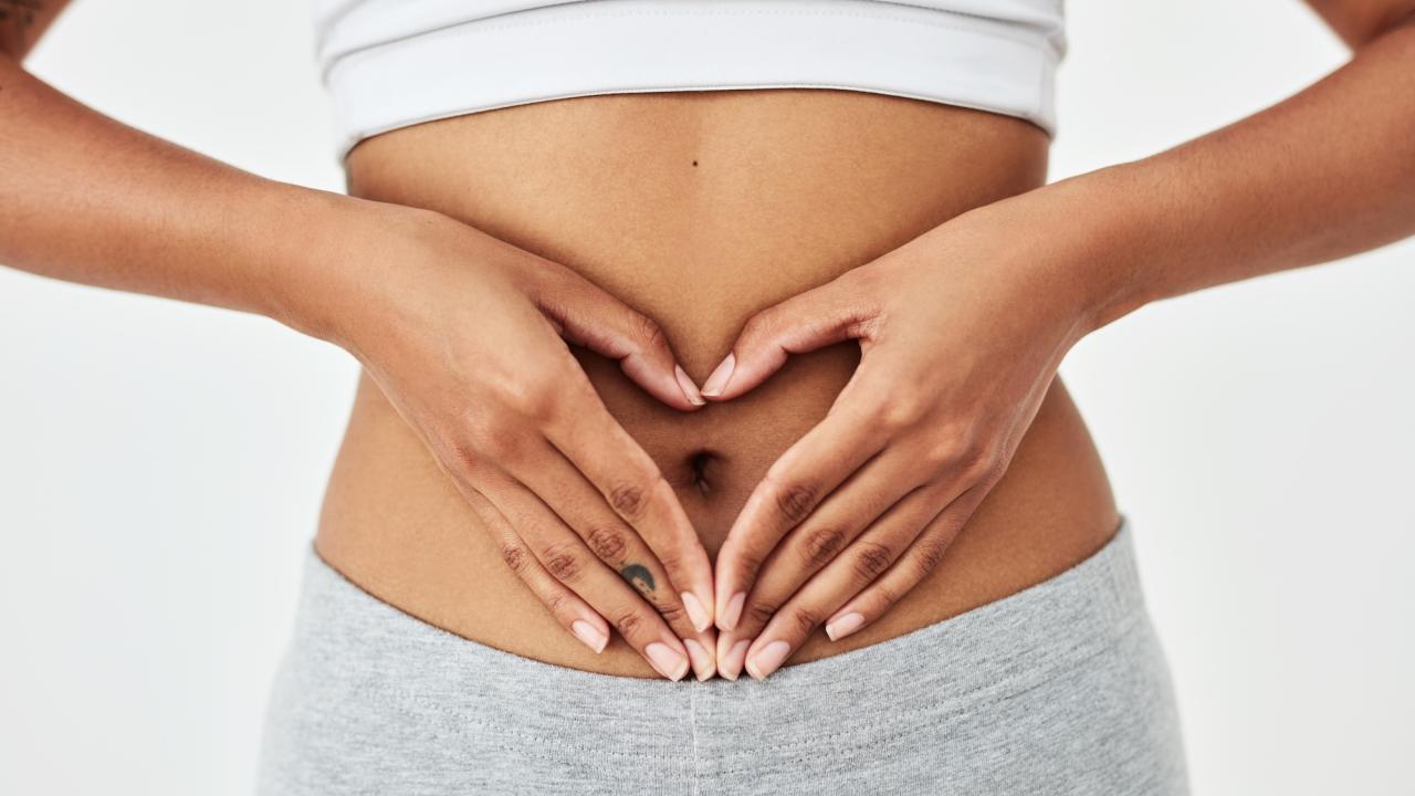 A person forming a heart shape with their hands over their abdomen. An international panel led by UC Davis professor Maria Marco defines “gut health” for the first time, offering a scientific framework for medicine, research and consumer claims. (Getty)