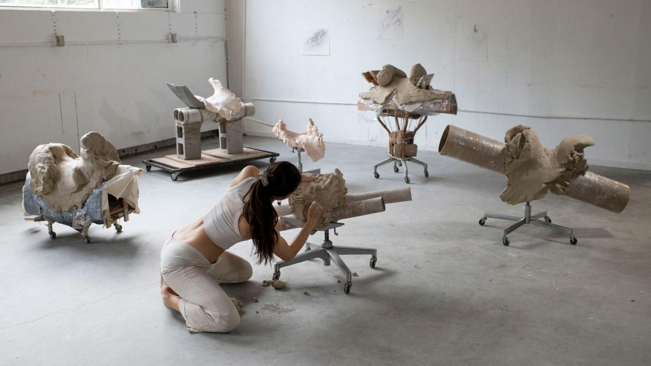 Photo of woman working on sculptures