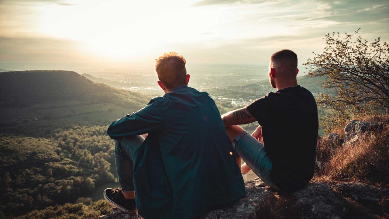 Two men looking at sunset.