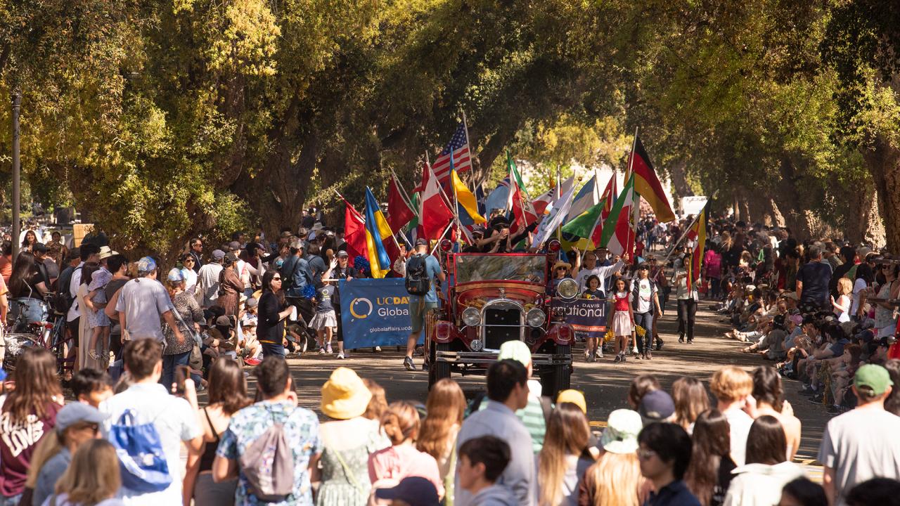 A view of the Picnic Day Parade with the crowd watching from the sidelines.