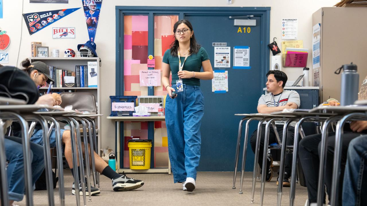 Photo of teacher walking through a classroom