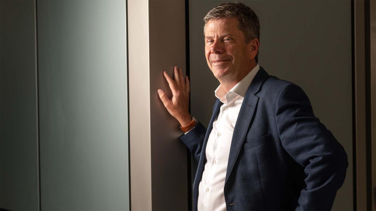 Simon Cherry leans against wall