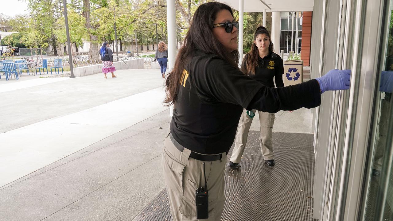 Two students check to see if door is locked.