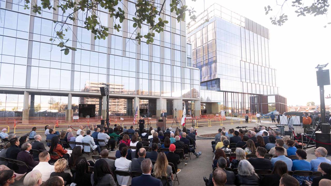 Crowd listens to speech at Aggie Square.