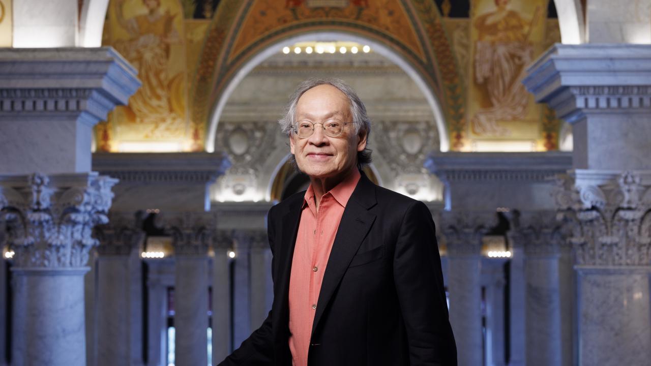 man standing in front of ornate building edifice