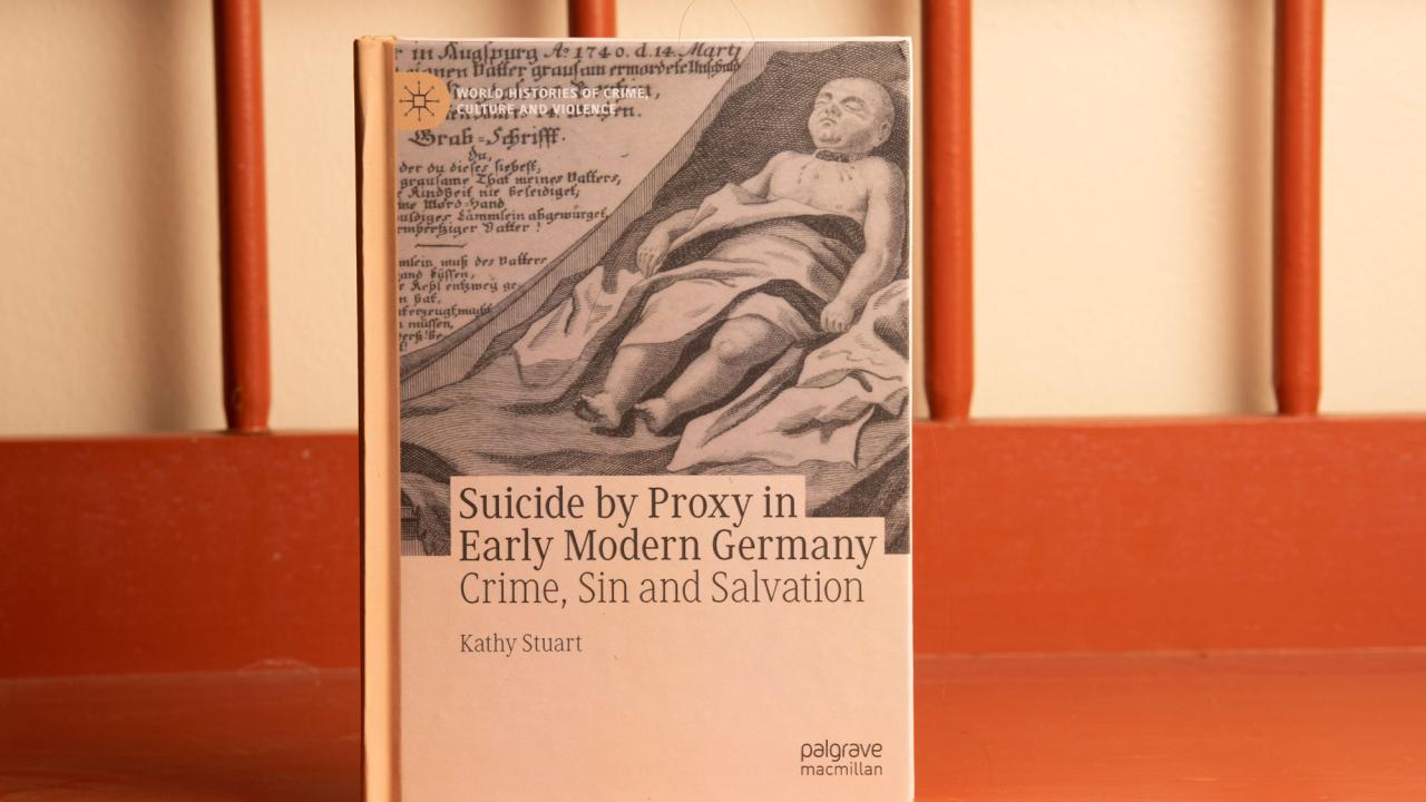 Book in sepia tones sitting on wooden chair