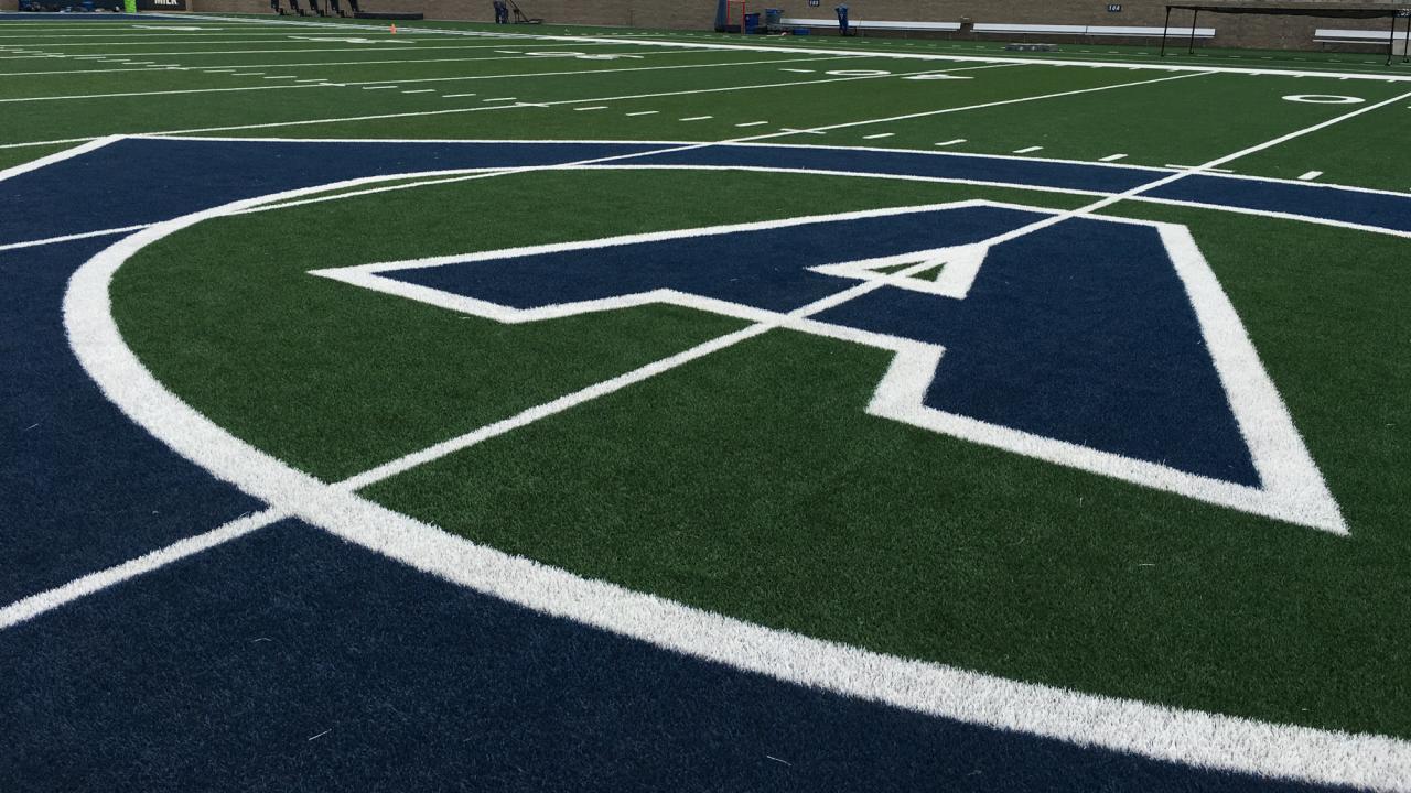 "CA" athletics logo painted on 50-year line of football field