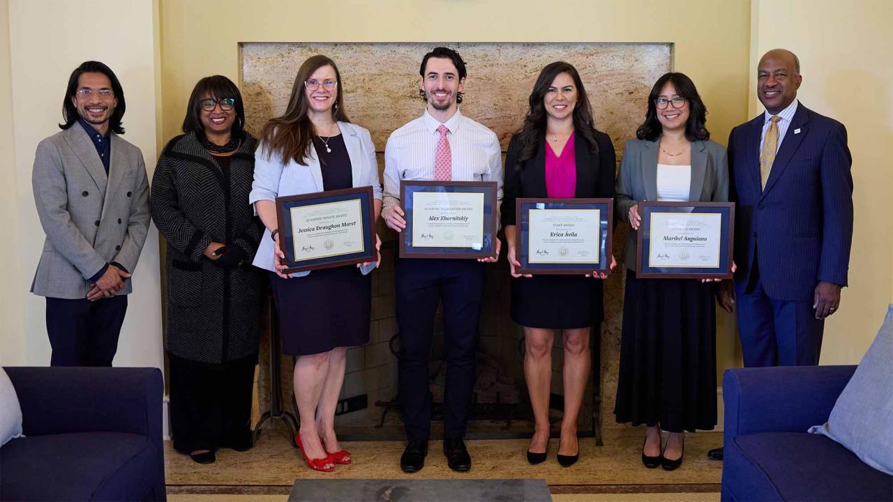 Group photo shows people posing with awards
