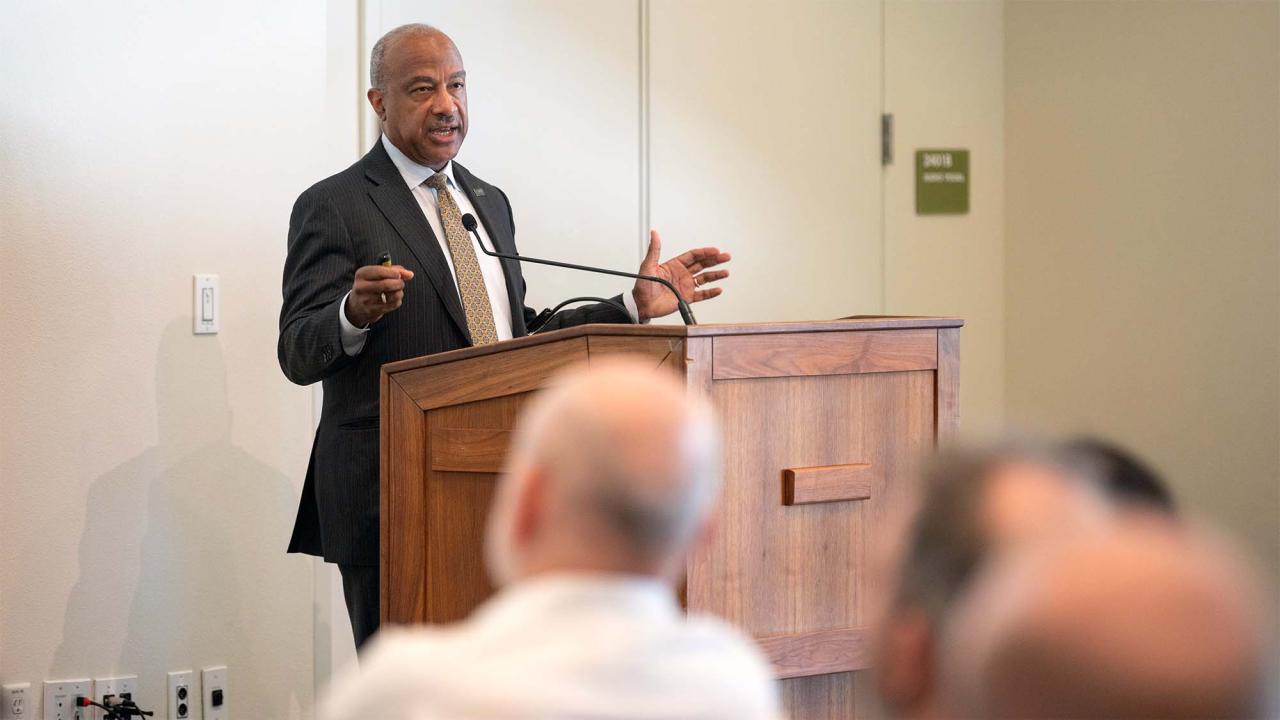 Chancellor Gary S. May speaks, standing at a lectern.