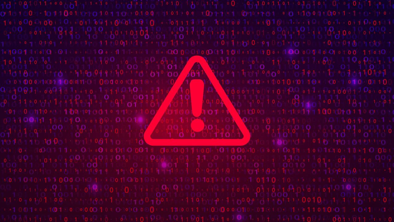 Alert symbol: Red triangle and exclamation point against background of computer code