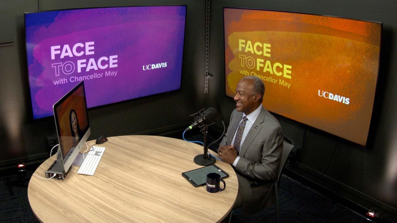 Chancellor Gary S. May films a video interview with Claudia Silva Gomes.