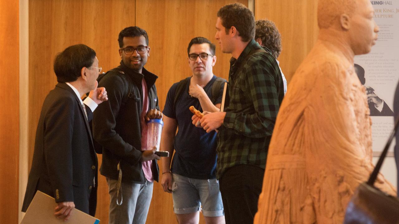 students talk to professor after class