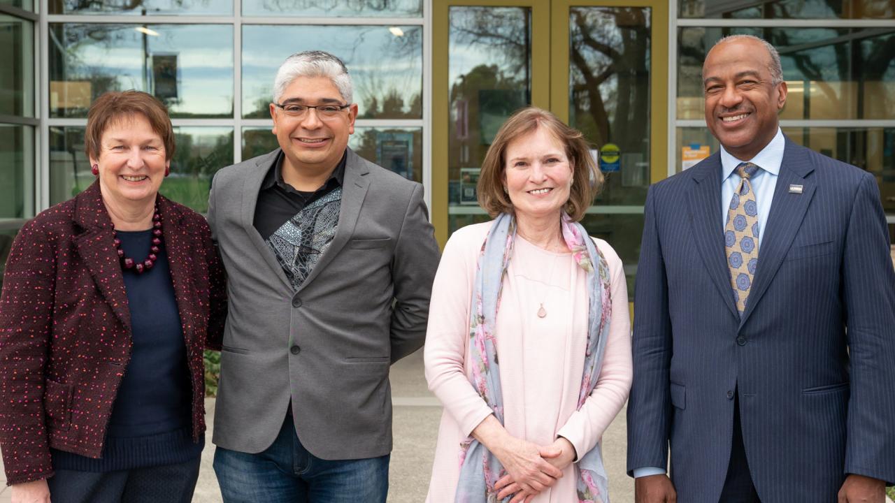 Two women and two men, posed