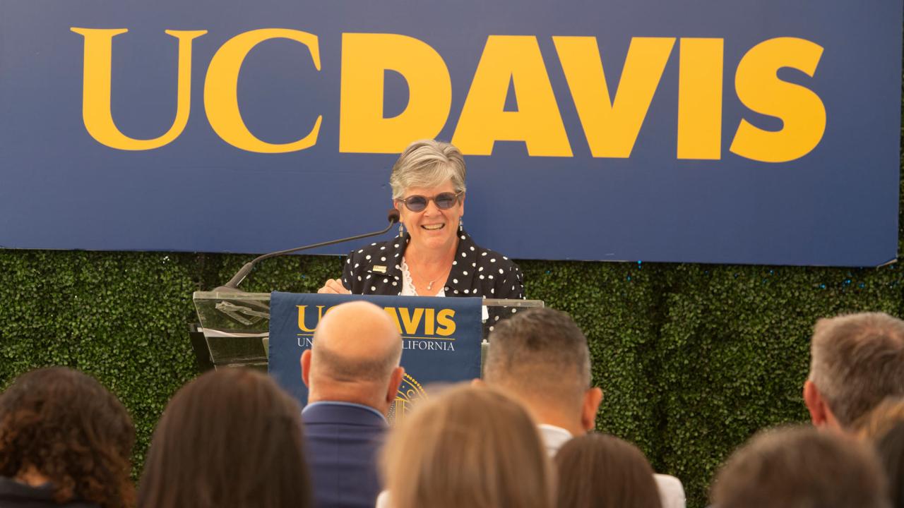 Vice Chancellor Kelly Ratliff at podium, "UC Davis" banner behind her