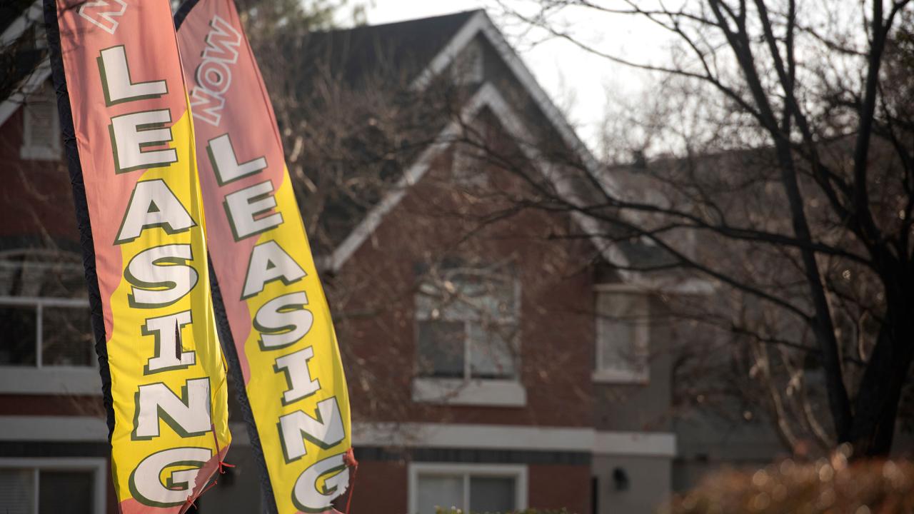 Leasing flags in front of an apartment complex