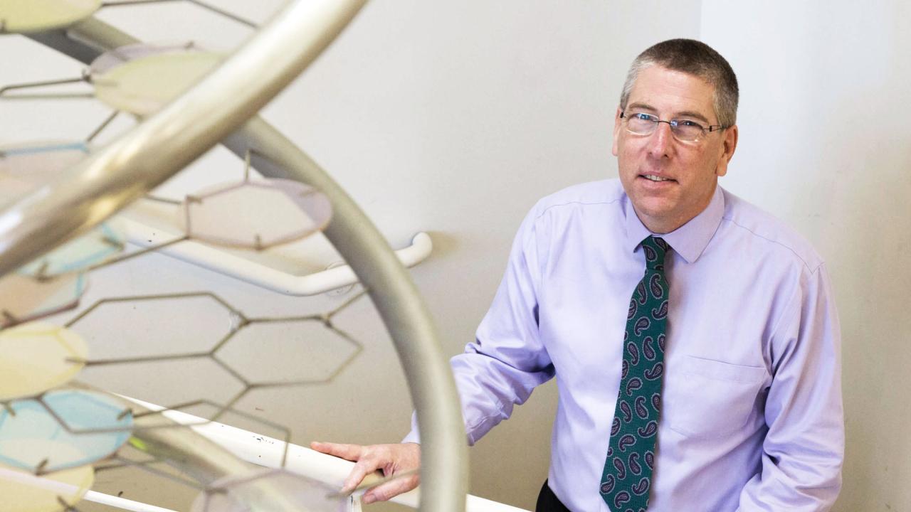 Mark Winey portrait, with DNA sculpture in stairwell